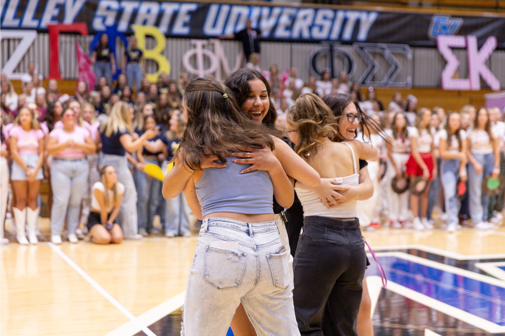 students embracing after receiving an invitation to join a sorority